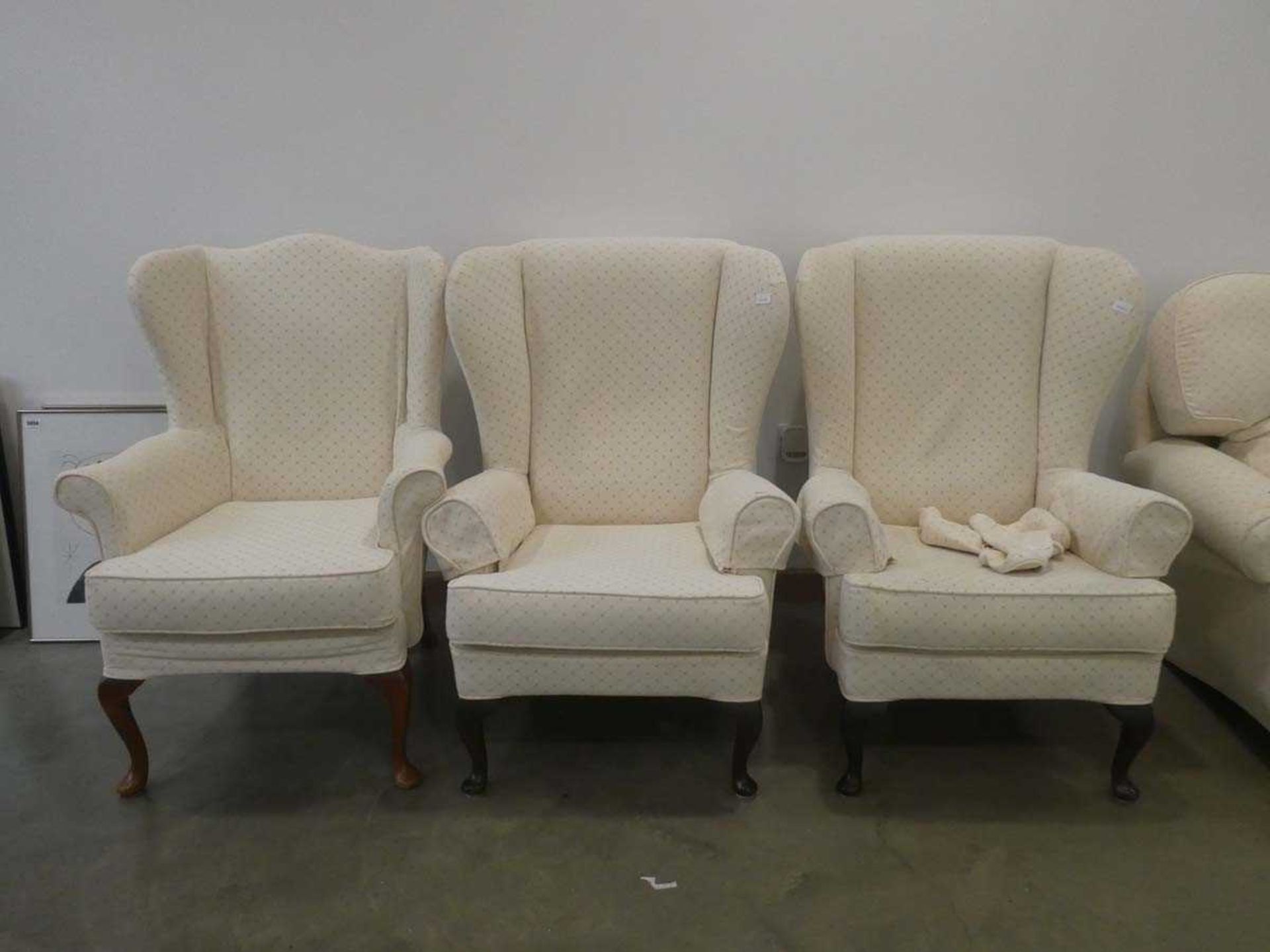 Three diamond patterned wingback armchairs