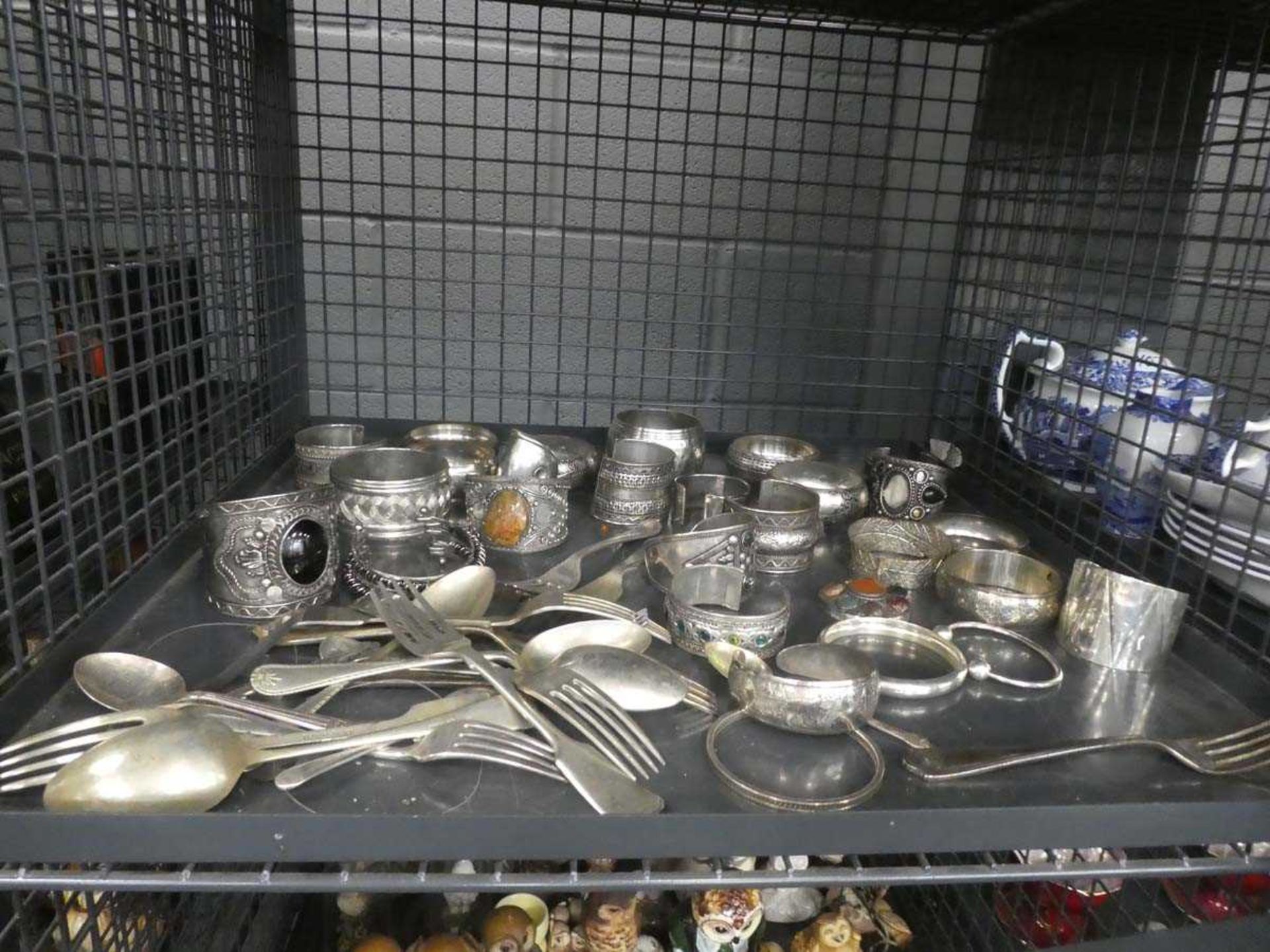 Cage containing loose cutlery plus a quantity of metal ware bangles
