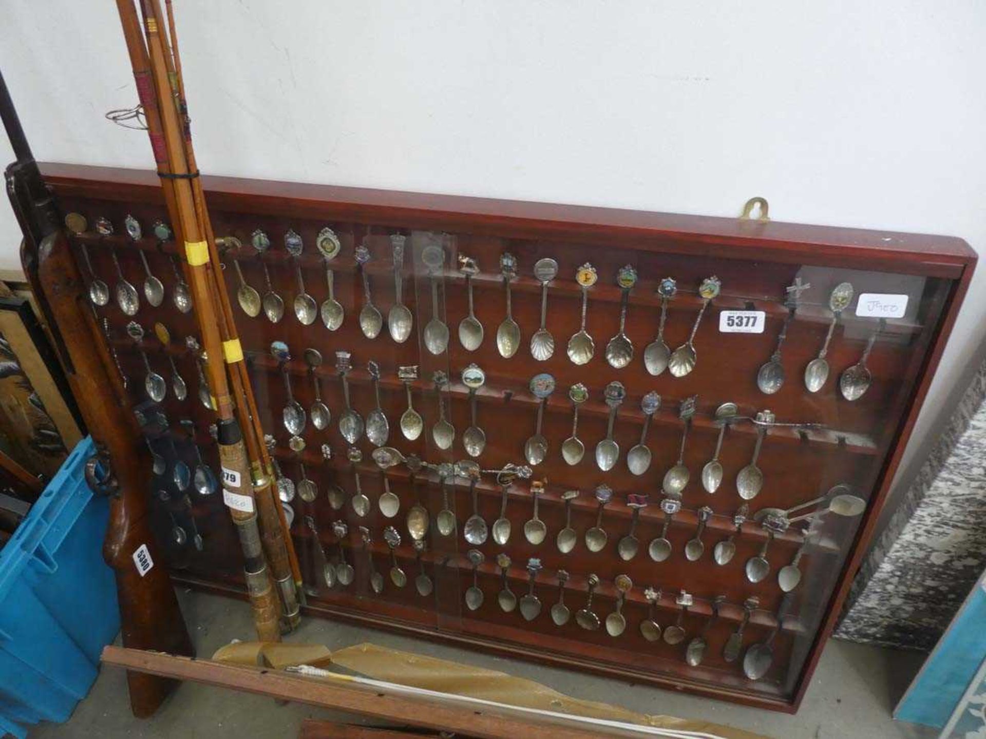 Souvenir spoon collection in cabinet