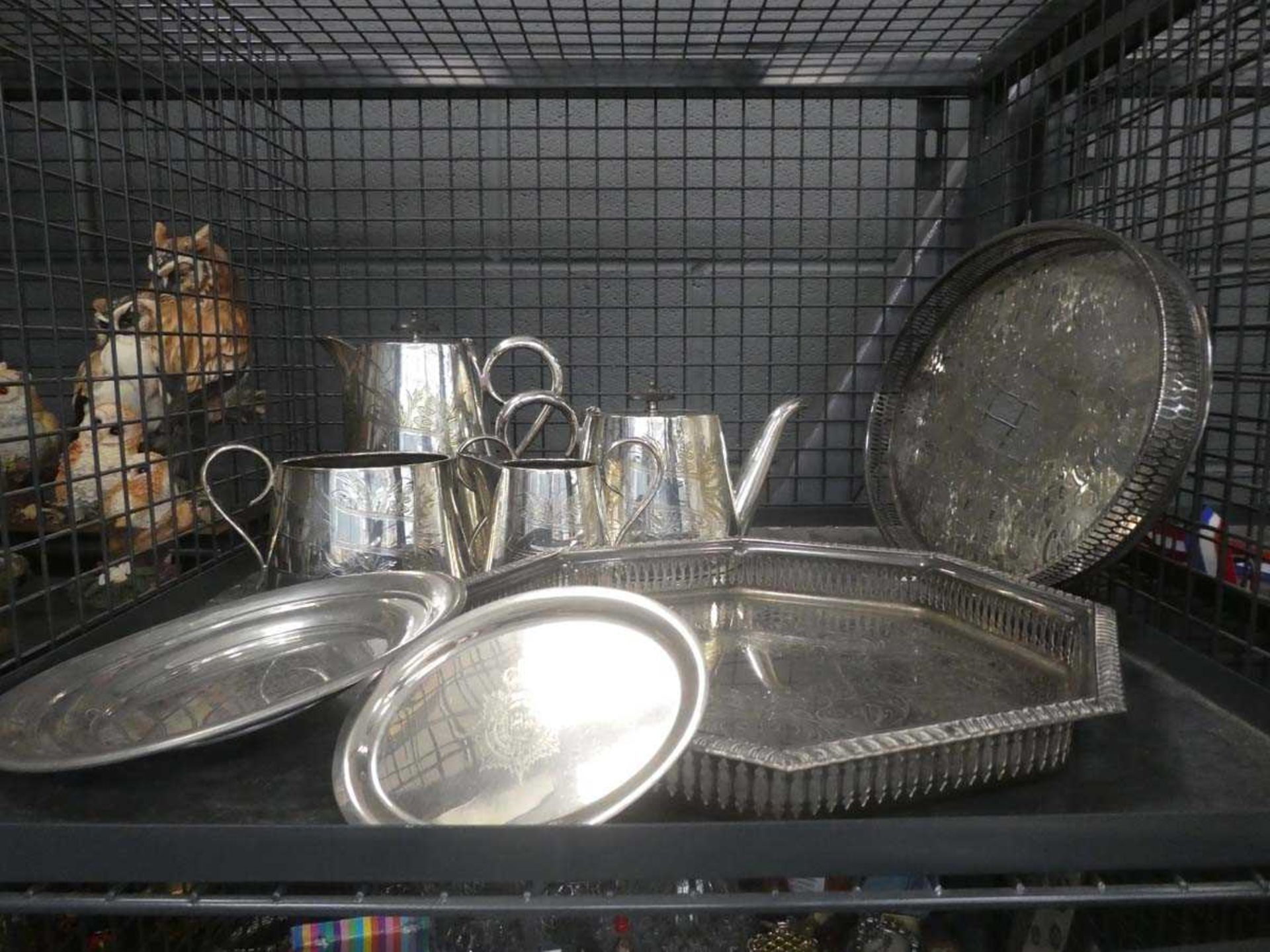 Cage containing a silver plated tea service plus gallery trays and dishes