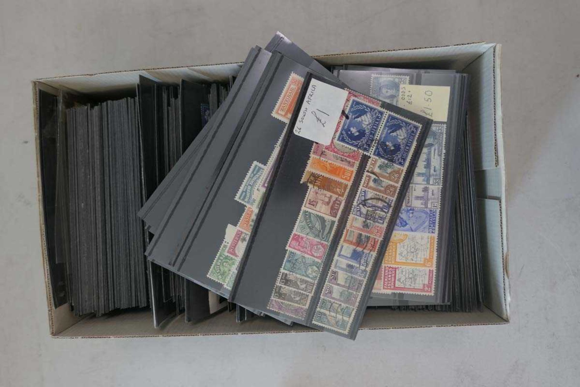 Shoebox containing Commonwealth stamps on stock cards