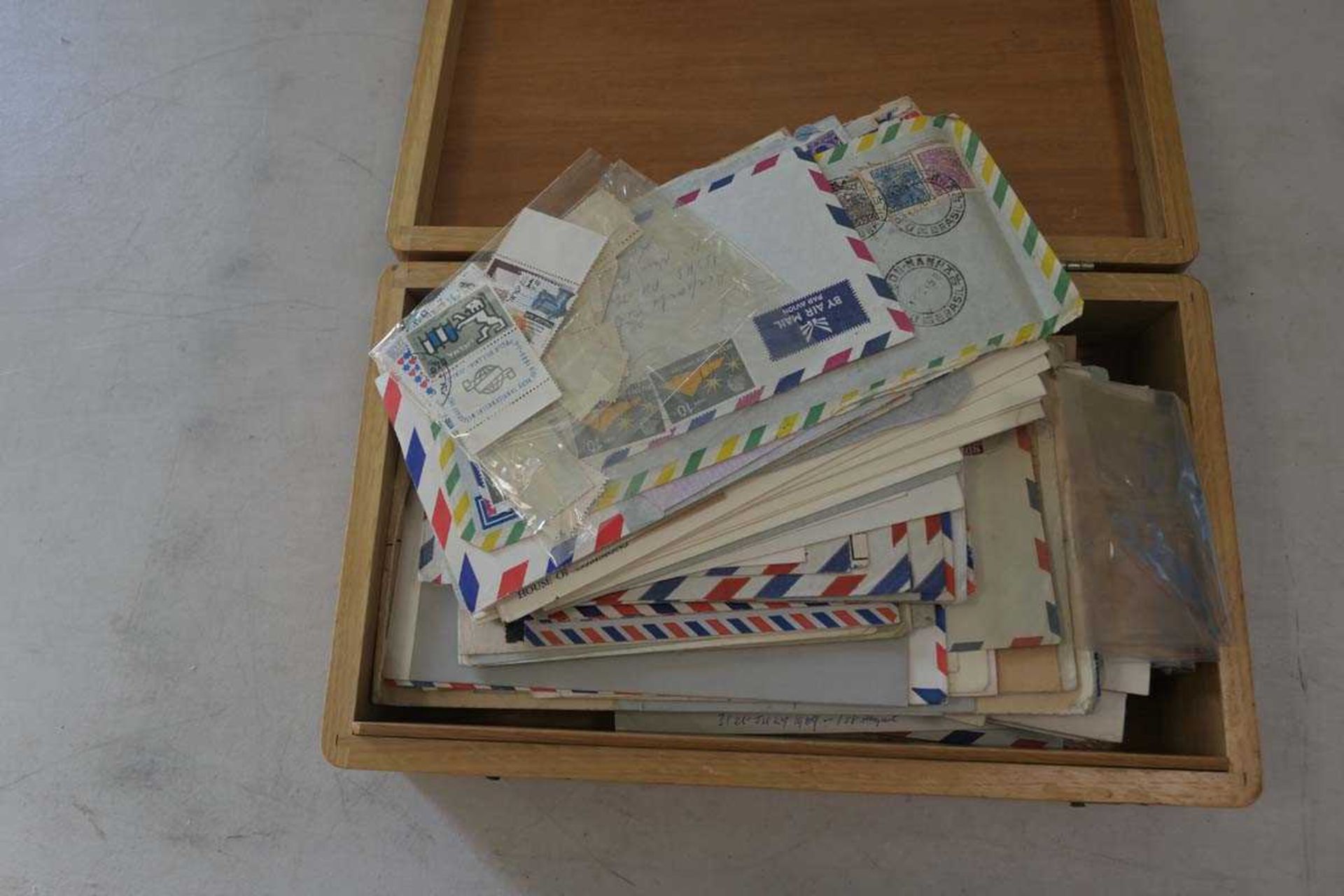 Wooden box containing Europe and World stamps on stock cards/covers