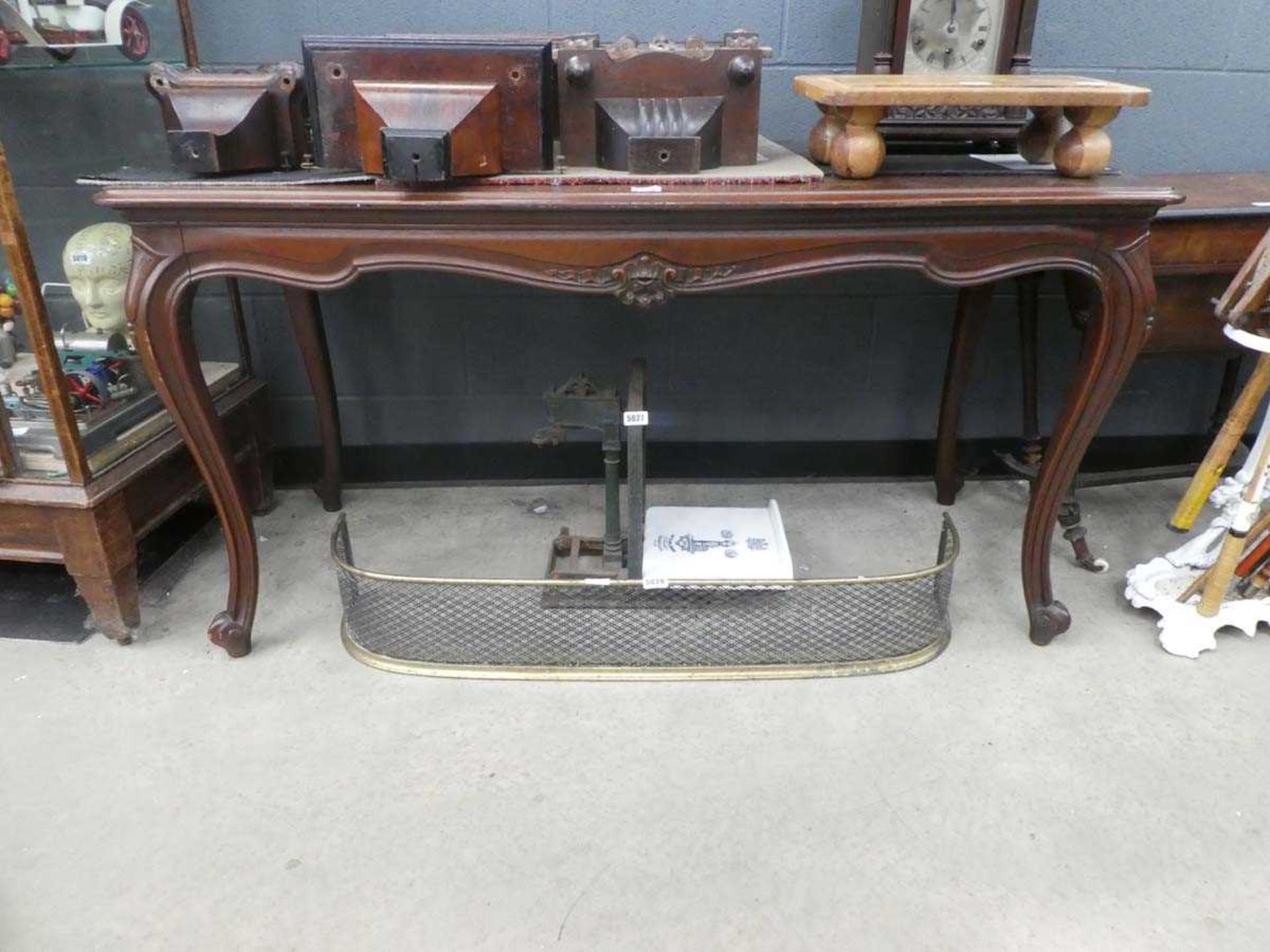 A 19th century mahogany centre or dining table of cushioned serpentine form with four cabriole