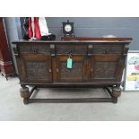 Oak sideboard with heavily carved panels