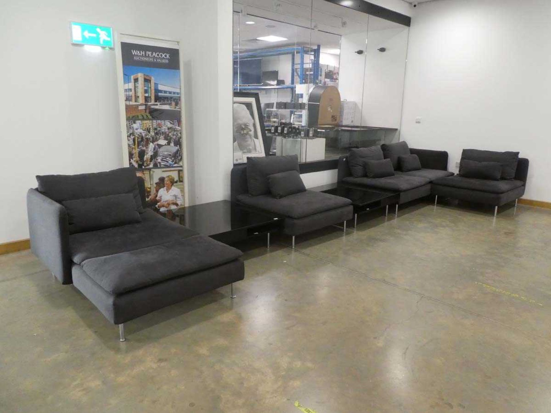 Grey fabric modular sofa in 4 sections plus a pair of high glass coffee tables