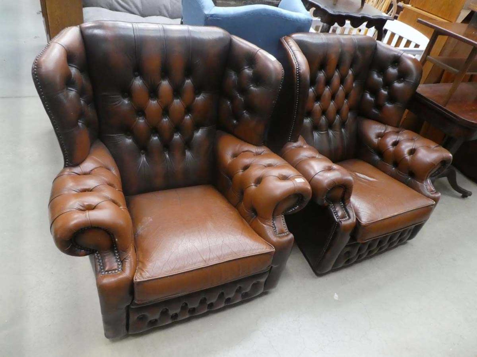 Pair of brown leather effect wingback armchairs