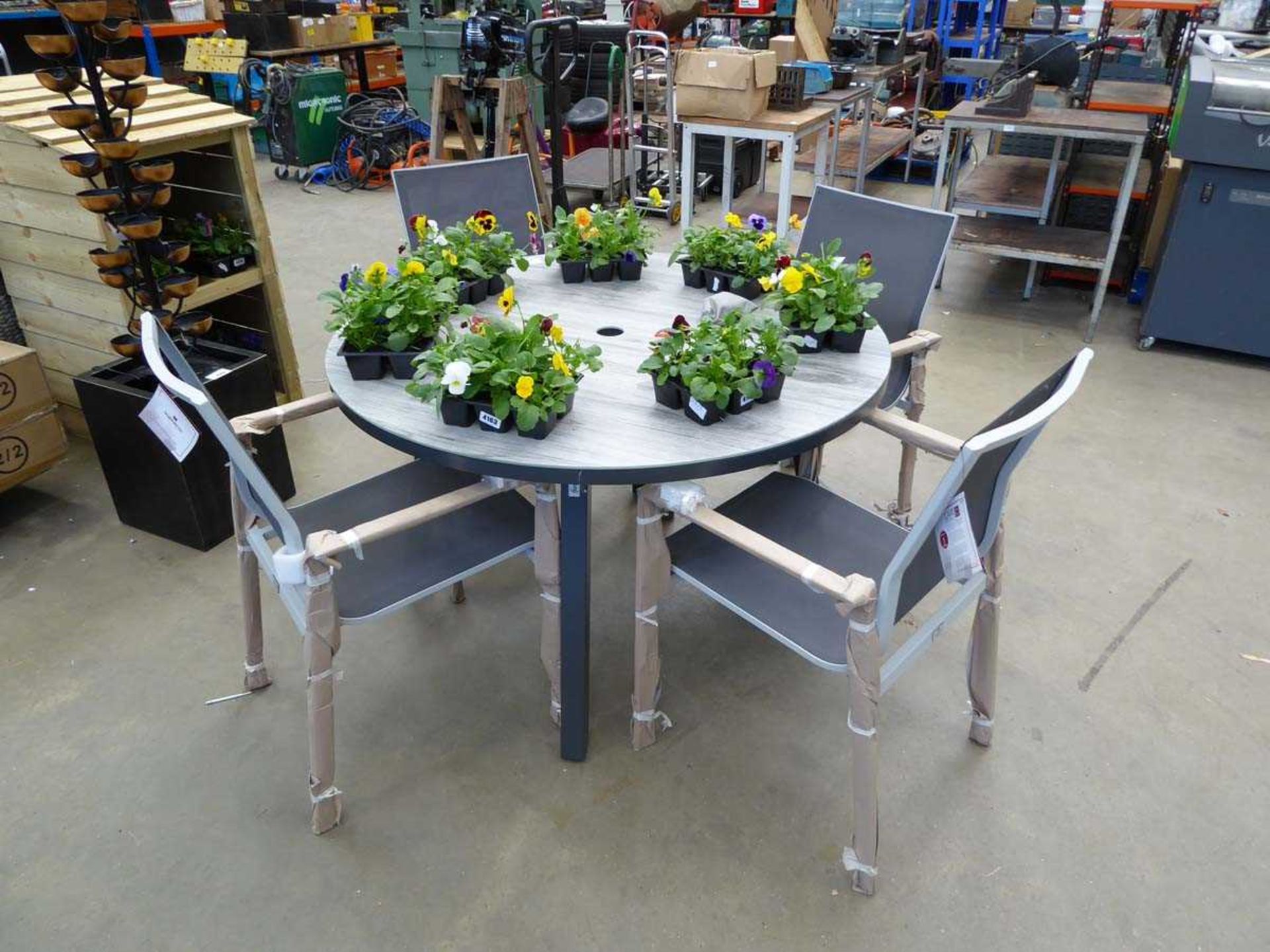 +VAT Wood effect round glass topped garden table and four metal framed grey garden chairs