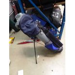 Blue and grey golf bag with assorted clubs