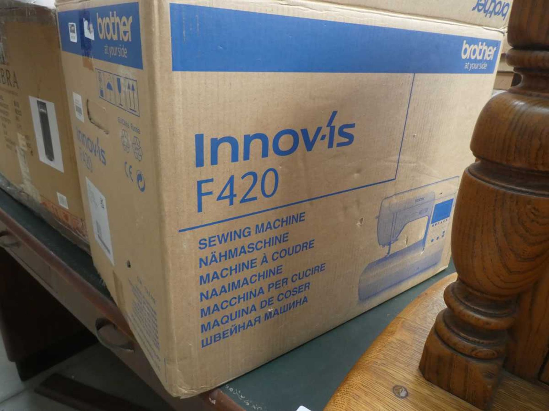 Three boxes containing lighting and sewing machine