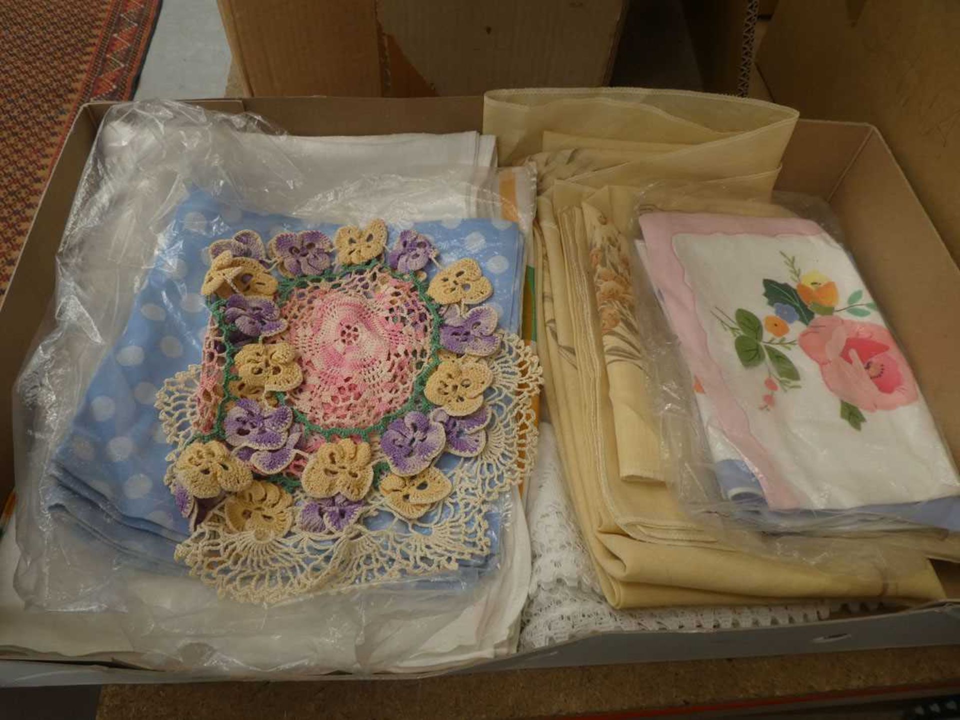 Box containing table cloths and doilies