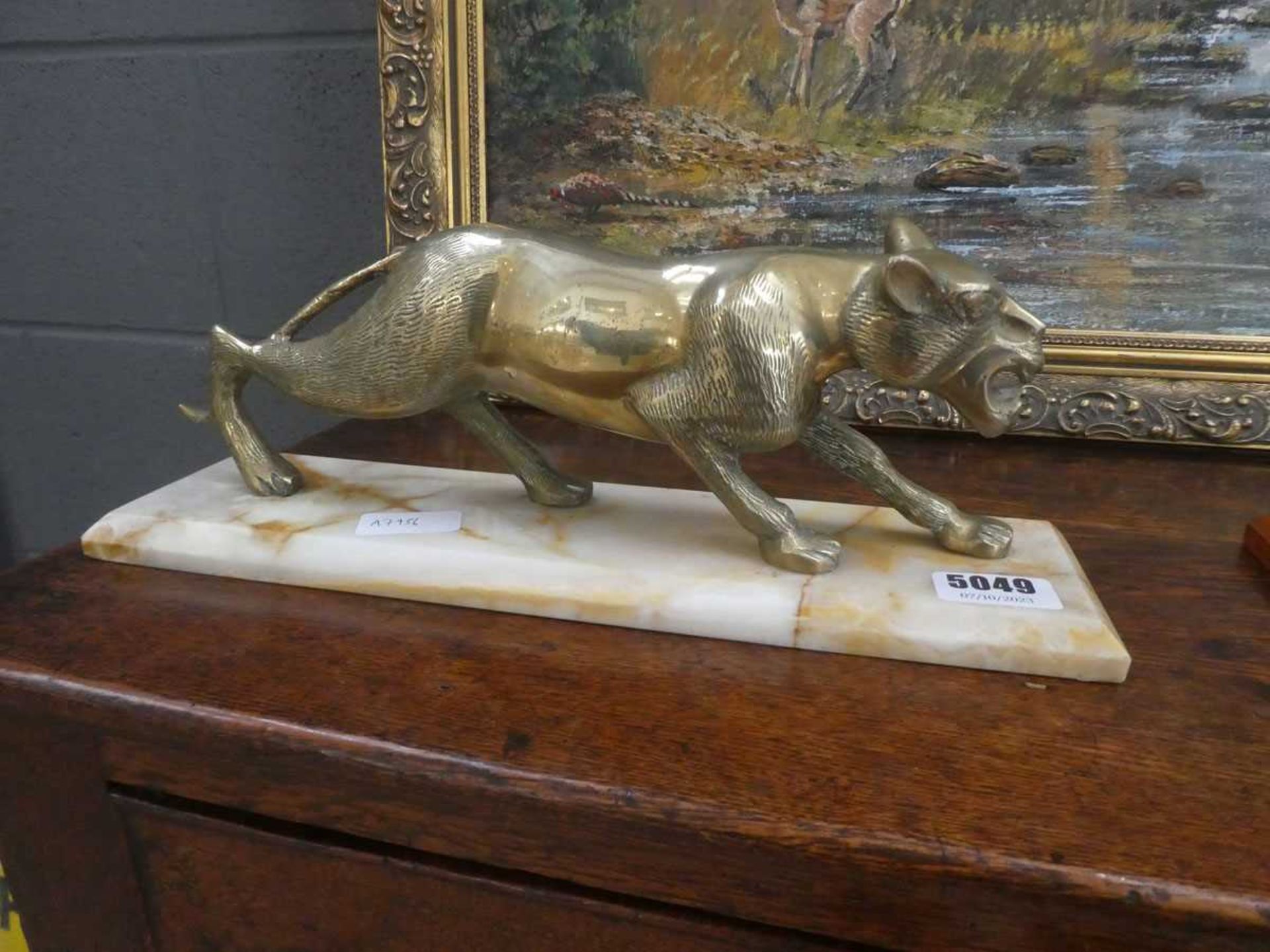 Brass figure modelled as a panther on a marble base