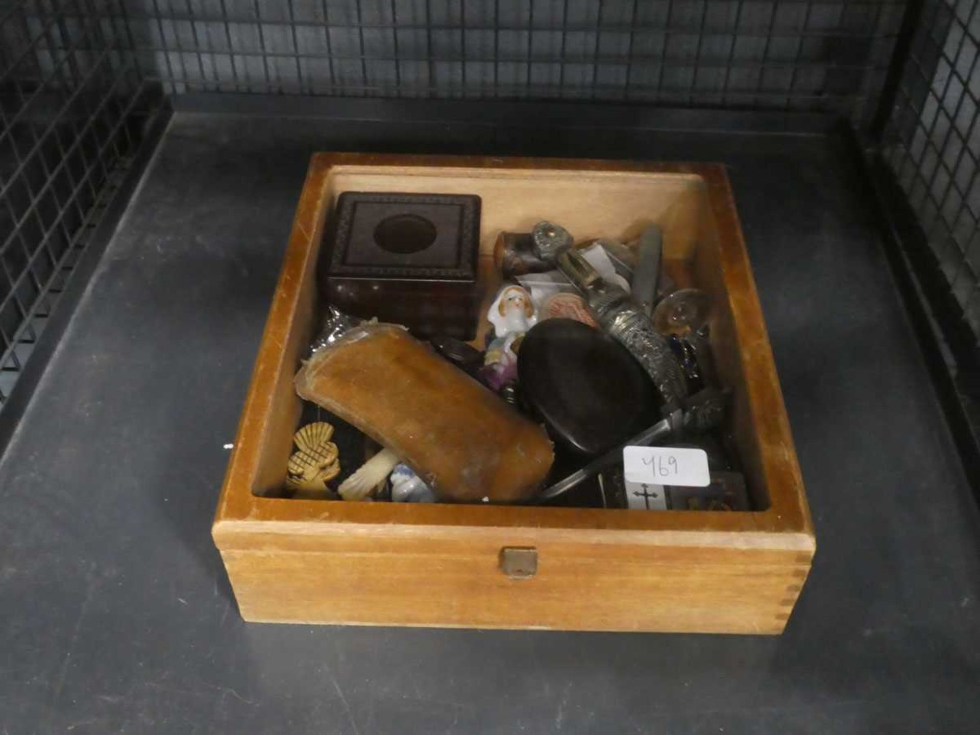 Small display box containing letter openers, spectacles, carved Scottish bone spoon and ornaments