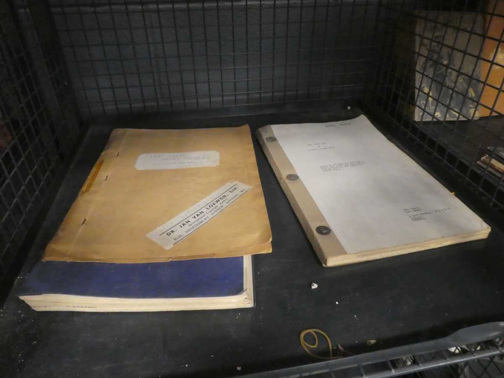 Cage containing play scripts