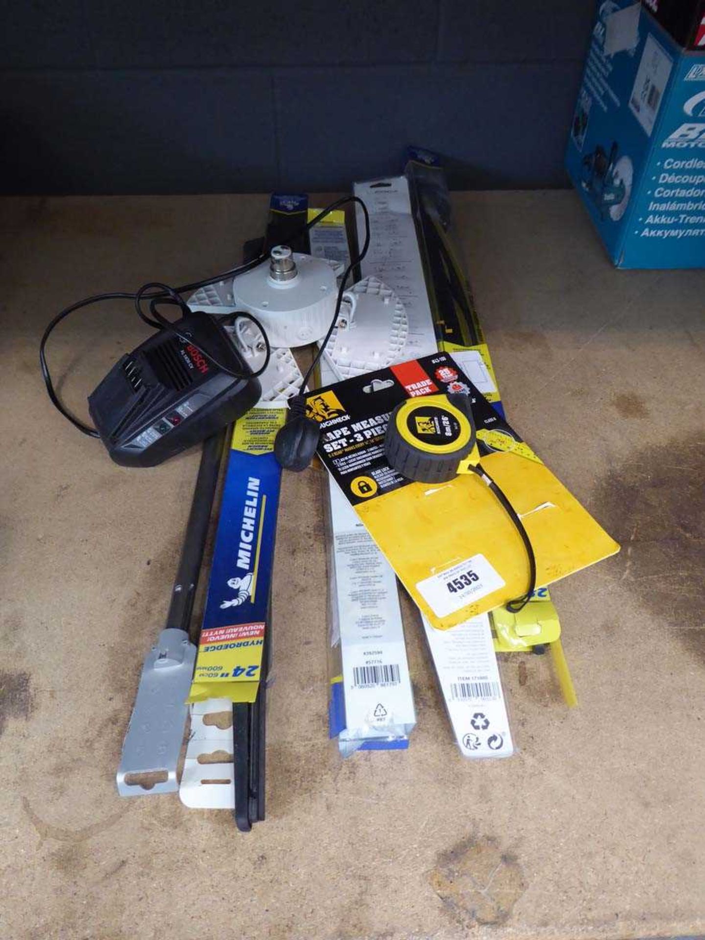 +VAT Various windscreen wipers, Bosch battery charger and a measuring tape, and light