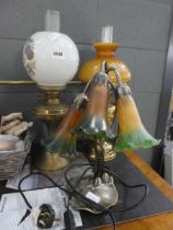 Two brass oil lamps with glass shades and reservoirs. Plus modern 3 branch lily shaped table lamp