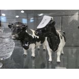 Two black and white Beswick cattle figures