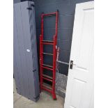 Red metal and wooden step ladder and a platform