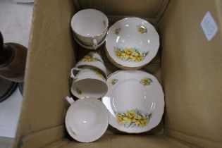 Box containing daffodil patterned Colclough cups, saucers and side plates
