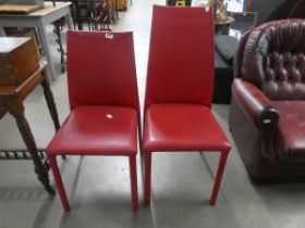 Pair of red leather effect dining chairs
