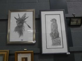 2 black and white framed pictures of a bird and a meerkat on the look out