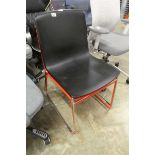2 Herman Miller plastic seated chairs on metal tubular legs in red and black