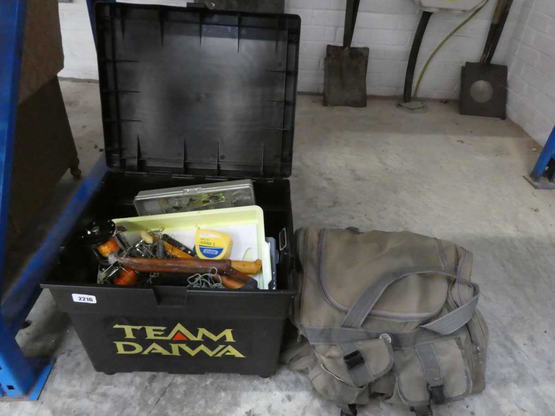 Team Daiwa fishing tackle box containing a quantity of mixed fishing tackle, together with a fishing