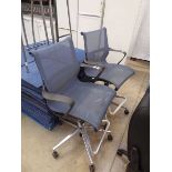 Pair of Herman Miller blue and grey mesh back twin arm office arm chairs on chrome 5 star bases