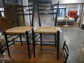 Set of 4 rush seated rush seated dining chairs on black frames, possibly Danish