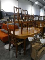 Mid century teak oval extending dining table by Nathan Furniture, together with 4 matching chairs