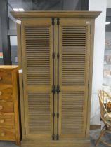 Modern oak clothes store, the double louvre doors with wrought iron features