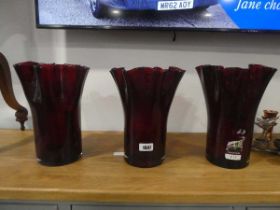 3 red glass vases, a quantity of various candle holders in the form of deer and birds, together with