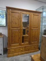 Modern pine triple fronted wardrobe with central mirrored door and 2 drawers to base