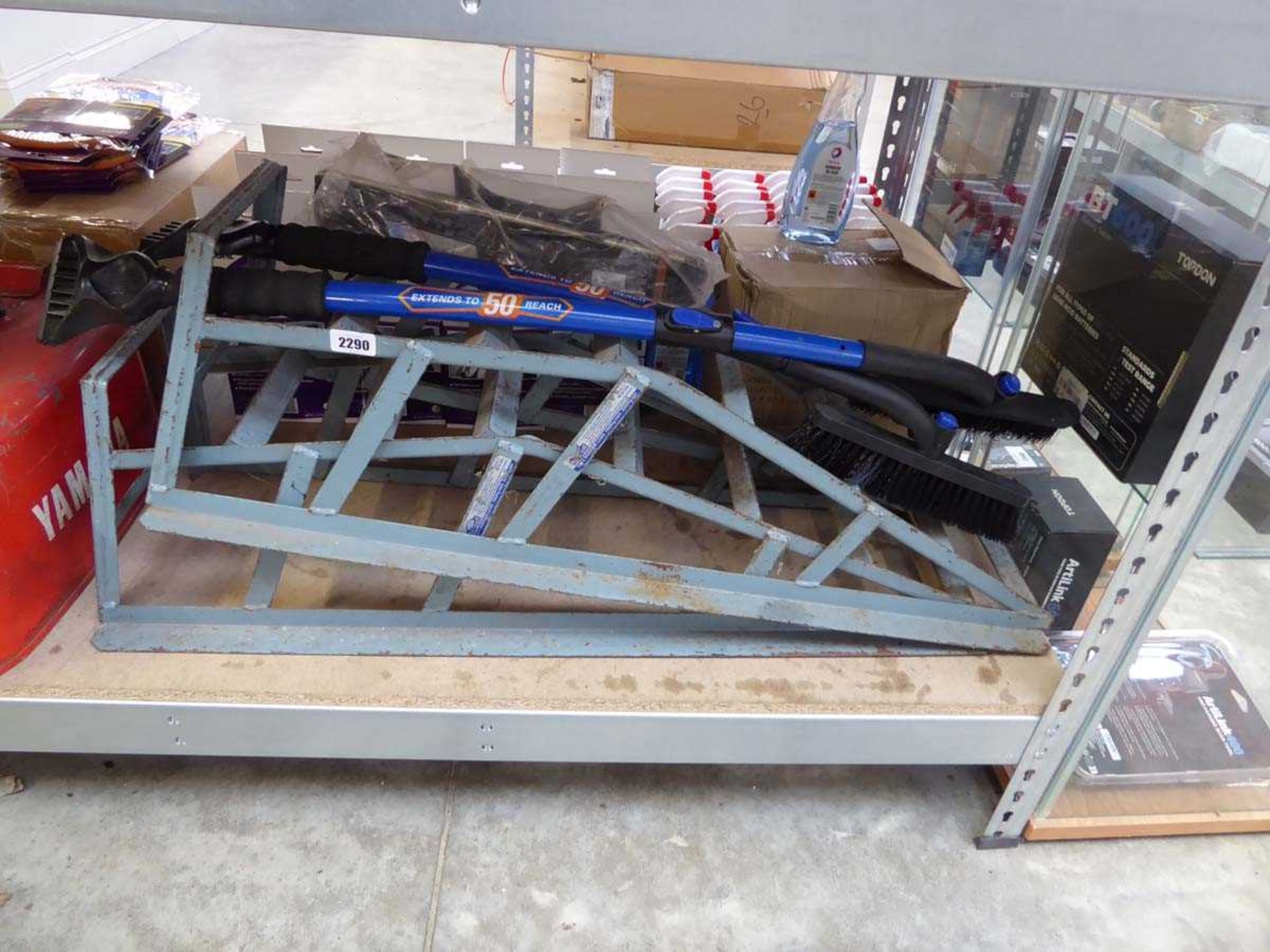Pair of metal car ramps together with a jack and 2 extendable scrappers