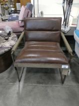 +VAT Brown leather upholstered low easy chair on metal frame