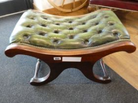 Green Chesterfield footstool on wooden supports