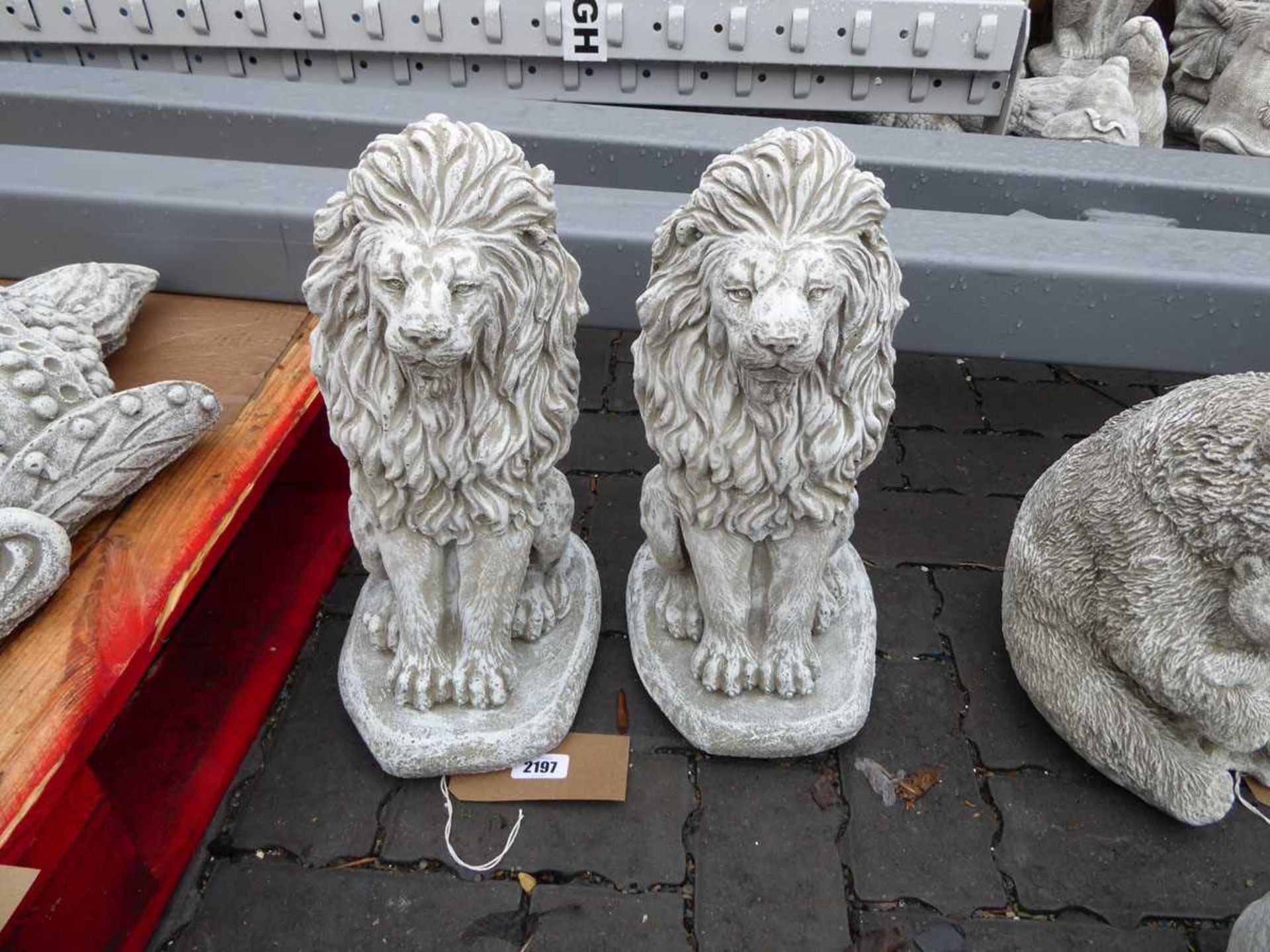 Pair of concrete lions sitting