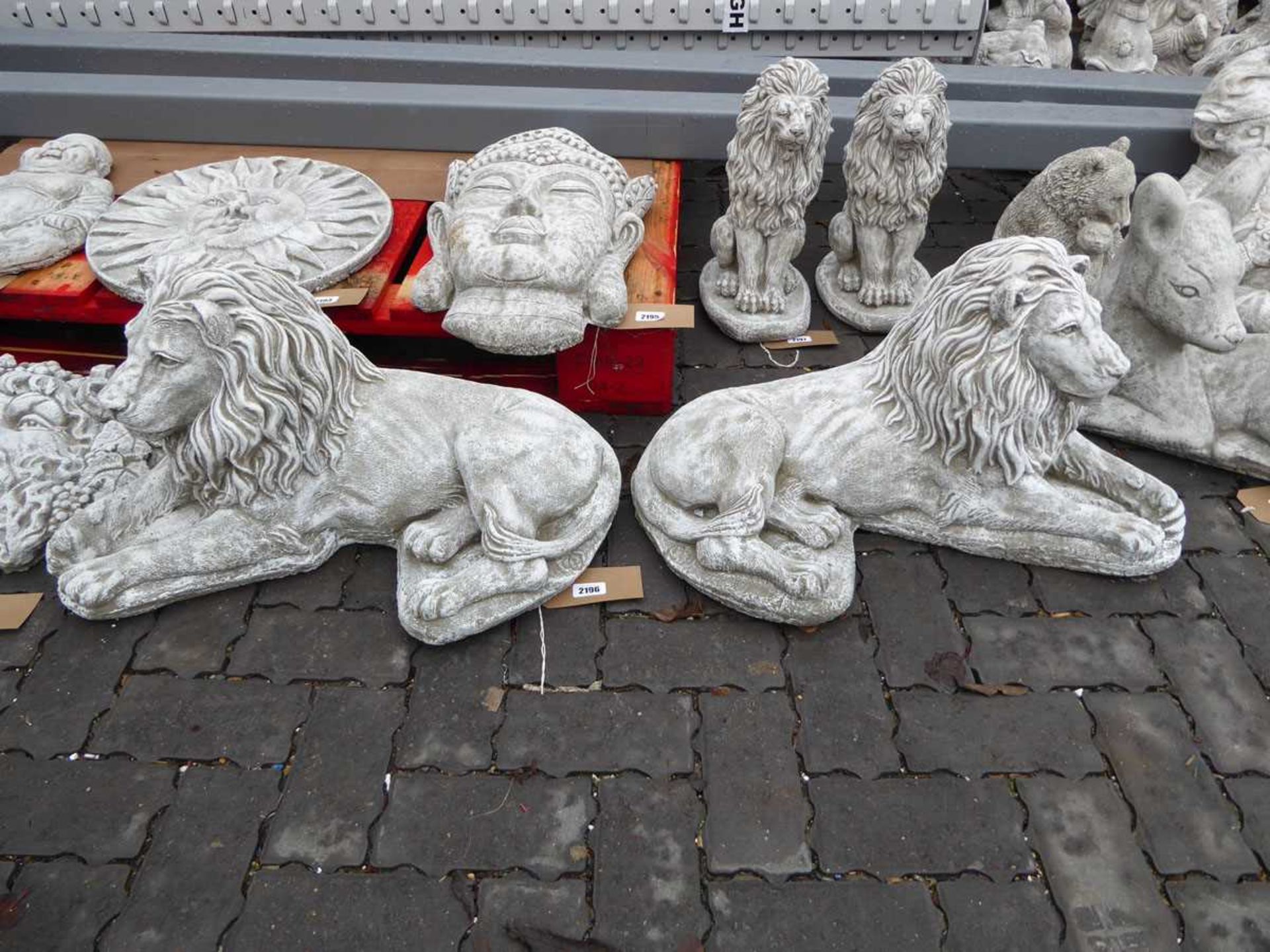 Pair of concrete lions lying down