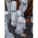 Pair of Easter Island head concrete ornaments