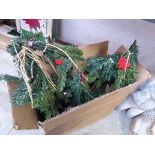 Box containing small Christmas trees and decorations