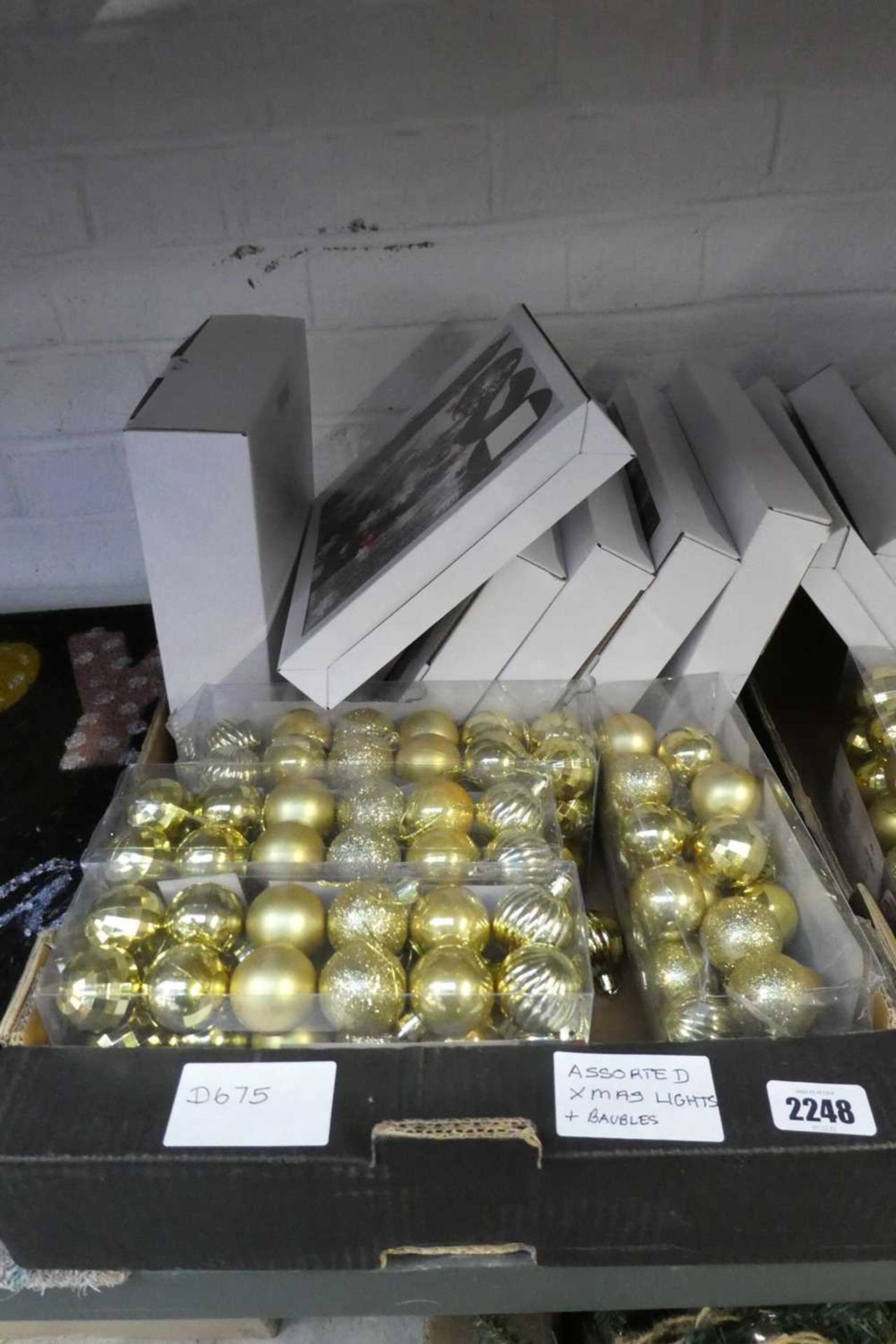 Box containing Christmas lights and baubles