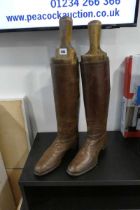 Pair of brown leather boots in wooden stretchers