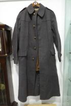 Long blue early 20th Century medical officer's overcoat with brown leather waistcoat