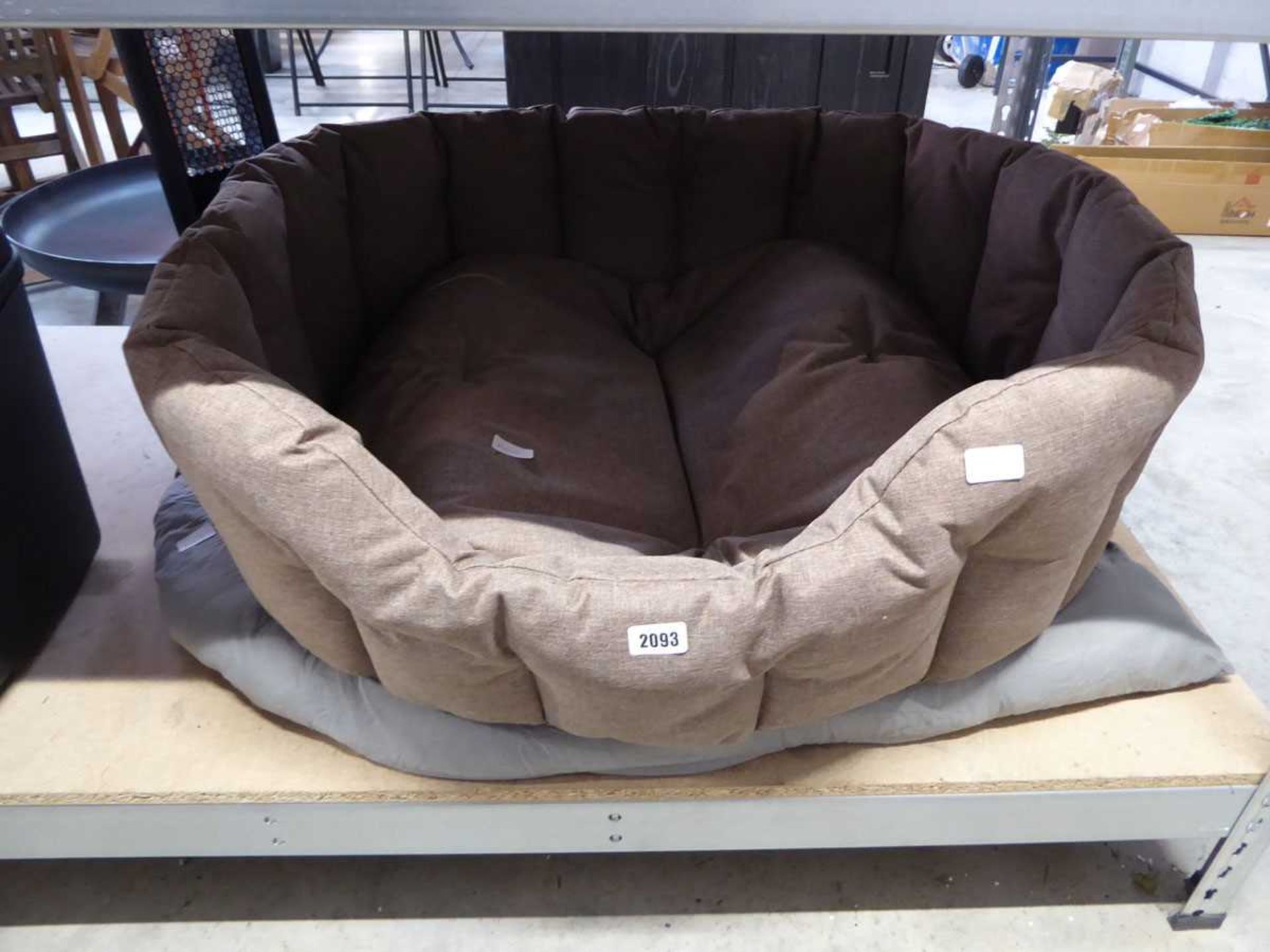 Brown semicircular dog bed with grey button back dog pillow