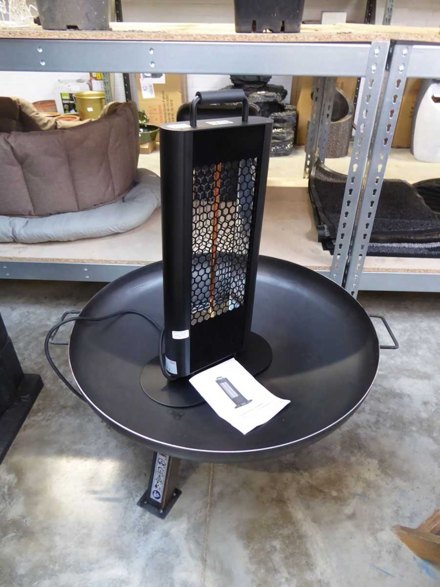 Black metal outdoor fire pit, together with an electric free standing patio heater