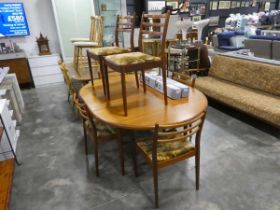 Mid century teak G-Plan extending circular dining table and 6 matching geometric upholstered