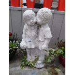 Concrete statue in the form of a boy kissing a girl