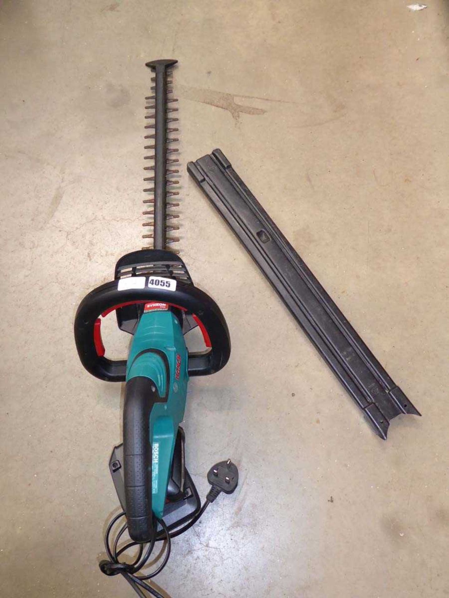 Battery powered hedge cutter with battery and charger