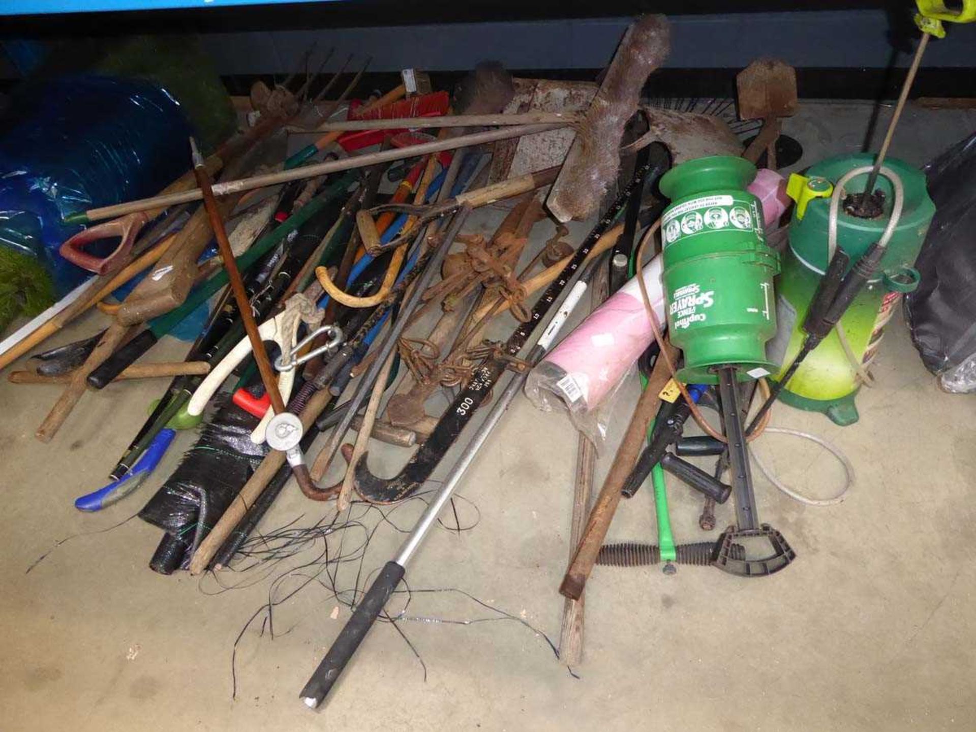 Half an under bay of assorted garden tools