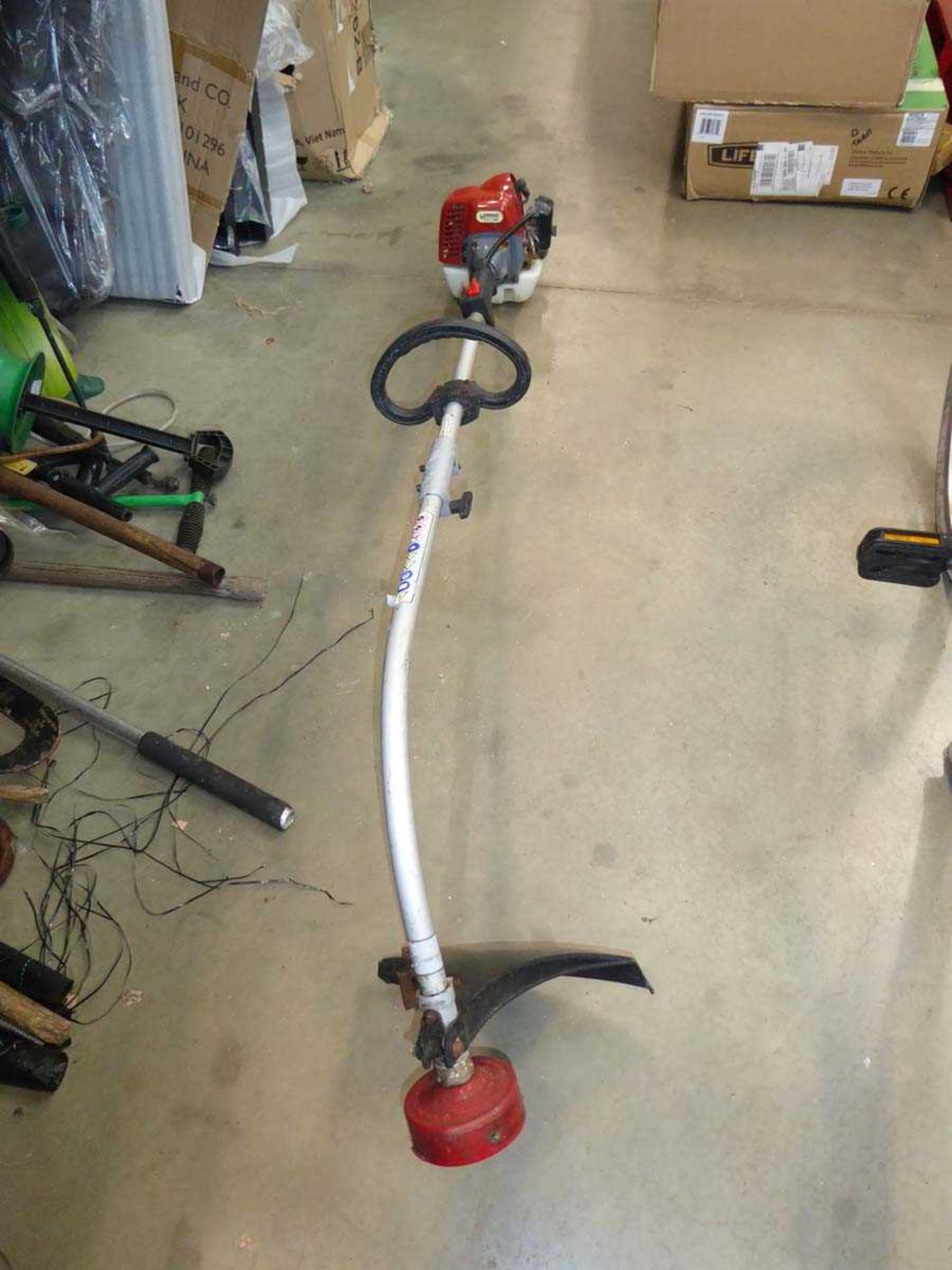 Petrol powered bench shaft strimmer in red