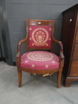 Carved French arm chair with embroidered seat and backrest